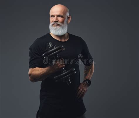 Strong Elderly Man With Dumbell Posing Against Grey Background Stock