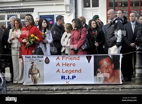 Mourners gather around a banner dedicated to Captain Daniel Read during