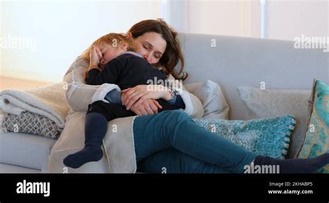 Mom Holding Her Toddler Son In Her Arms Mother And Child Falling