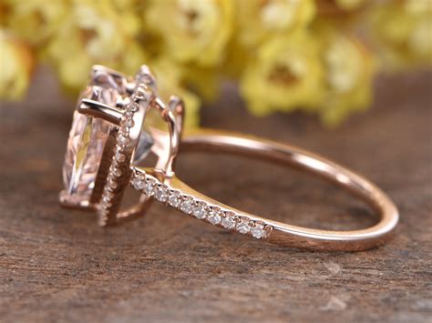 The gallery of this morganite heart engagement ring is open with delicate swirls ornamenting the bottom of the basket and the band is crafted into a cathedral setting raising the halo up a bit slightly off the circular portion. Morganite engagement ring rose gold diamond wedding band 10mm heart cut morganite ring pink ...