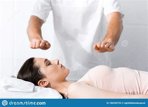 View Of Healer Standing Near Woman With Closed Eyes And Holding Hands