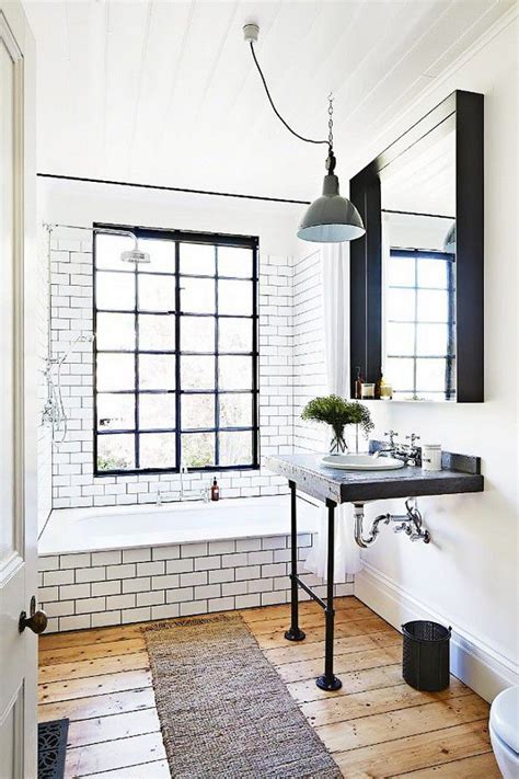 Simple tiny house bathroom with bench toilet, tiny floating sink, window and shower. 7 Tiny Bathrooms Brimming With Stylish Function