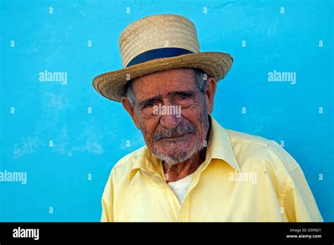 Portrait Of Old Cuban Man Posing In Front Of Pastel Coloured Wall In