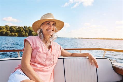 The Ocean Is Her Happy Place A Mature Woman Enjoying A Relaxing Boat Ride Stock Photo Image
