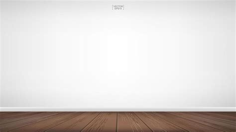 An Empty Room With Wooden Floors And White Walls