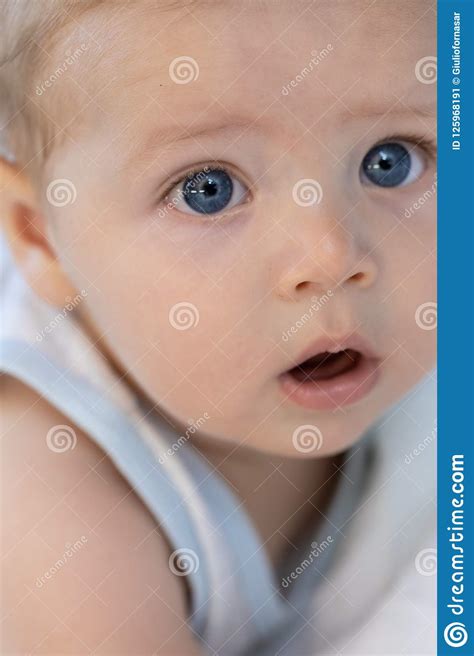 Little Baby With Large Trusting Blue Eyes Stock Image