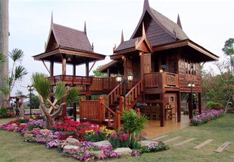 Two Wooden Buildings With Flowers In The Foreground