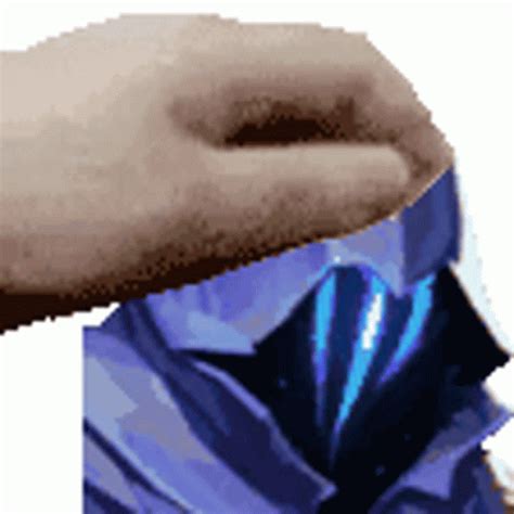 A Hand That Is Holding Something In It S Left Arm And Wearing A Blue Shirt