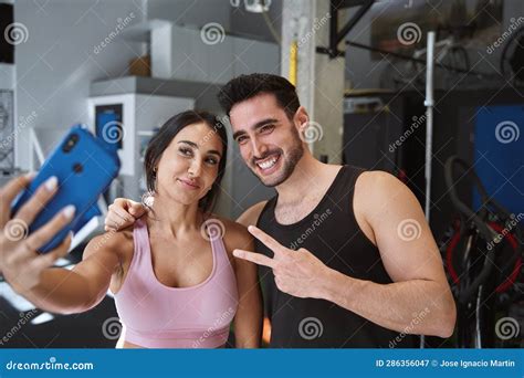 Brunette Fitness Couple Taking A Selfie With Their Phone After