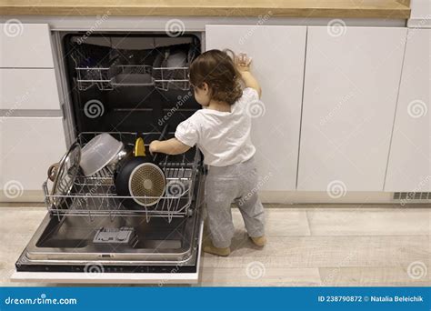 Little Cute Toddler Girl Helping To Unload Dishwasher Funny Little