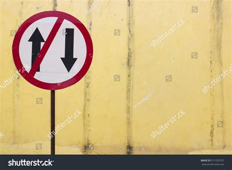 One Way Traffic Sign On A Yellow Background Stock Photo 511553737