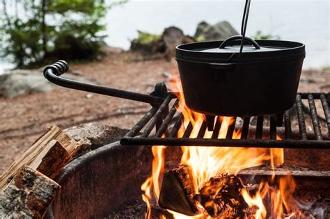 a dutch oven over a campfire in the woods