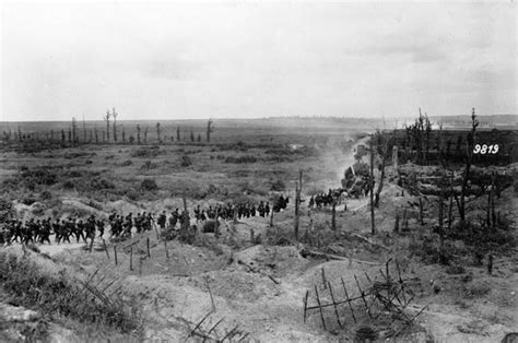 German Soldiers Advancing Past A Captured French Position Between