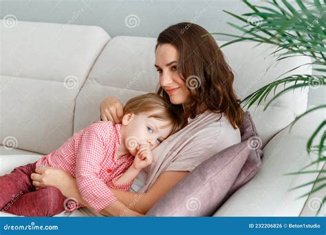 Bebé Está Chupando El Dedo Tumbado En El Pecho De La Madre En El Sofá
