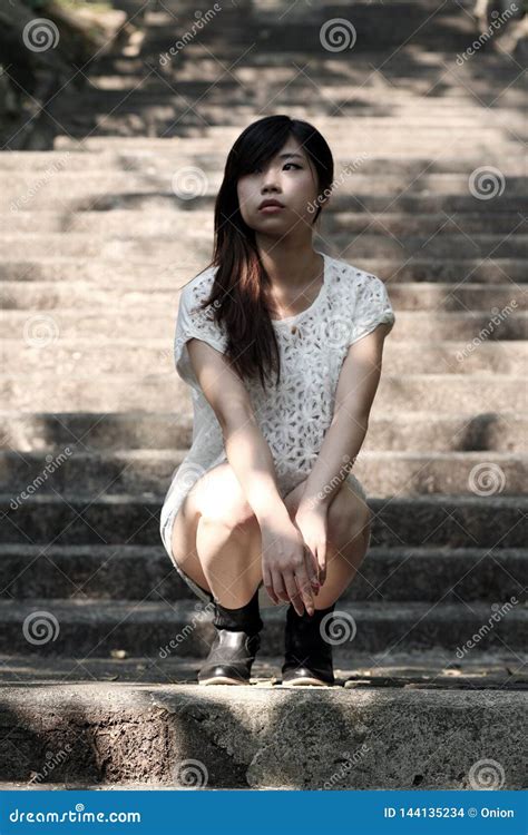 Beautiful Asian Woman Squatting On Cement Steps Stock Photo Cartoondealer Com