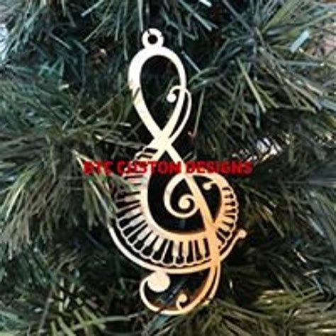 A Christmas Ornament Hanging From The Top Of A Tree With Music Notes On It