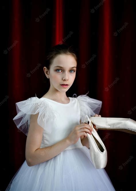 Premium Photo A Cute Ballerina Girl In A White Dress On A Red Background Art Dance Beauty
