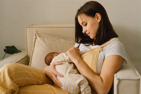Newborn Baby Boy Sucking Milk From Mothers Breast Portrait Of Osf