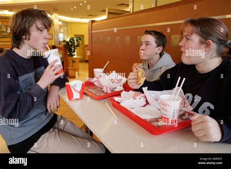 teenagers eating at a fast food restaurant Stock Photo - Alamy