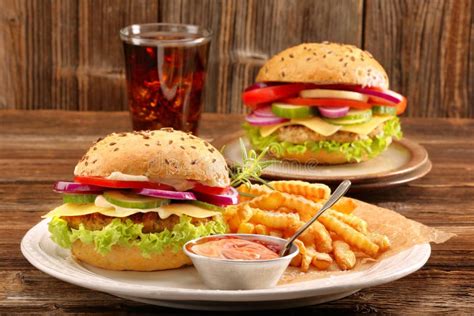 Fresh Tasty Burger With Fries And Drink On Wooden Table Stock Image