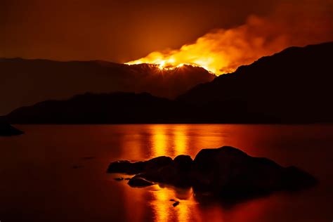 Forest Fire At Night Reflecting In Nearby Lake Drax
