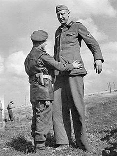 A Picture Capturing The Moment That The Tallest Member Of The German Army Surrendered To A