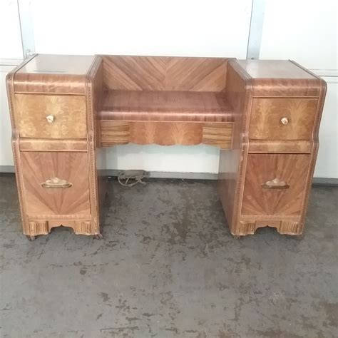 This old waterfall vanity was saved from the trash this vanity came to me with a broken mirror and missing hardware. Lot Detail - VINTAGE WATERFALL VANITY WITH MIRROR