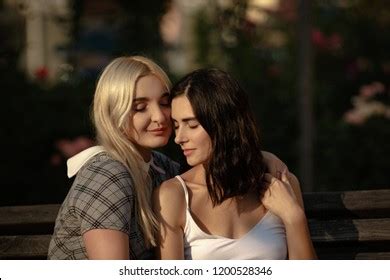 Blonde Brunette Lesbians Holding Each Other Stock Photo
