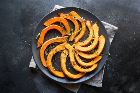 Roasted Sliced Pumpkin With Thyme And Salt Healthy Vegan Food Stock