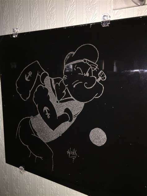 a black and white drawing of a man holding a baseball bat in his hand on a wall