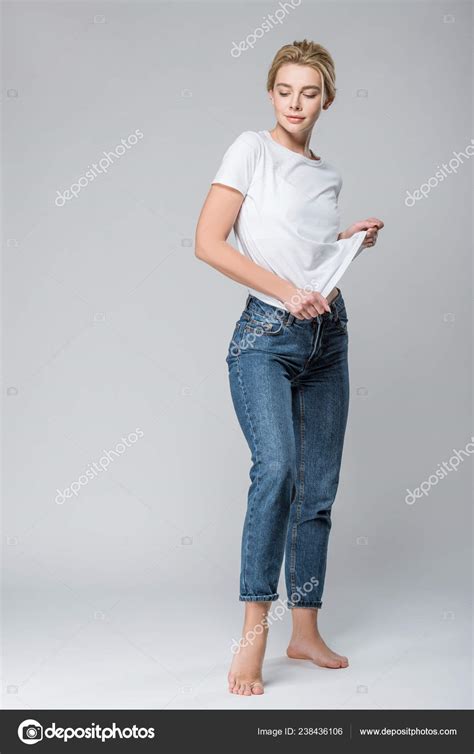 Beautiful Smiling Woman Jeans Undressing Isolated Grey Stock Photo