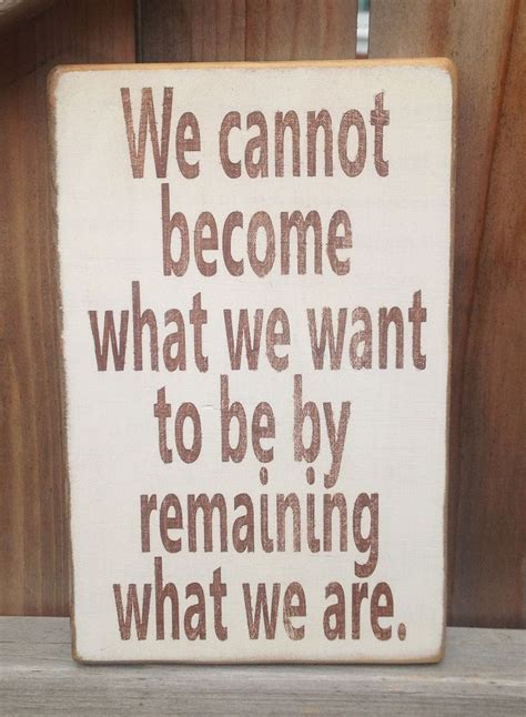 A Wooden Sign That Says We Cannott Become What We Want To Be By