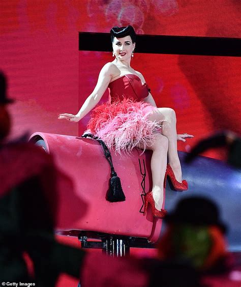 Dita Von Teese Puts On A Busty Display In A Plunging Scarlet Sweetheart