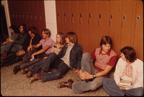 Students Resting In The Hall Against Their Lockers Waiting For Class At