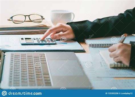 Accountant Working On Desk And Using Calculator With Pen