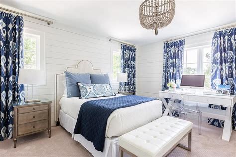 Navy blue bedroom walls by tlcinteriors.com. White and blue bedroom boasts shiplap walls lined with a ...
