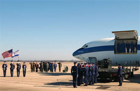 A Us Air Force Usaf Honor Guard Places A Coffin Carrying The Remains