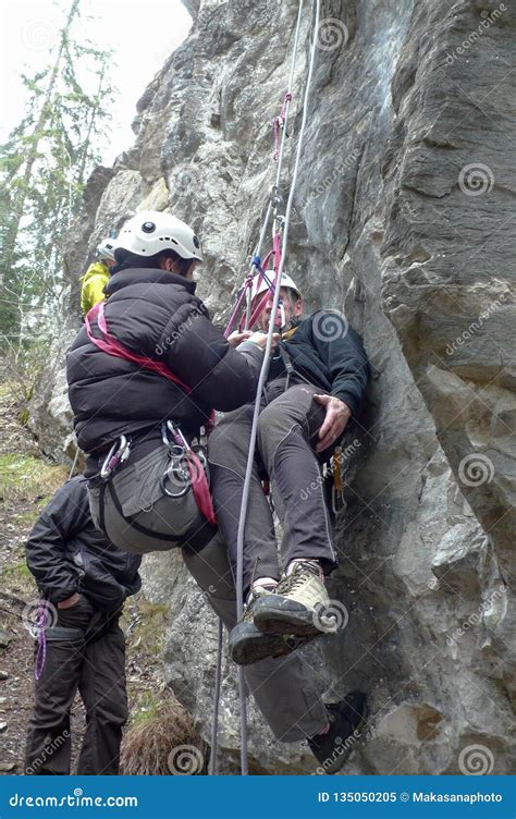 Rescuing An Injured Rock Climber With A System Of Ropes And Climbing