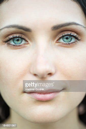 A Beautiful Woman Staring Serenely Into The Camera Closeup Of Face High