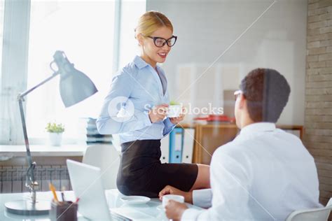 Charming Secretary Talking To Her Boss During Coffee Break Royalty Free