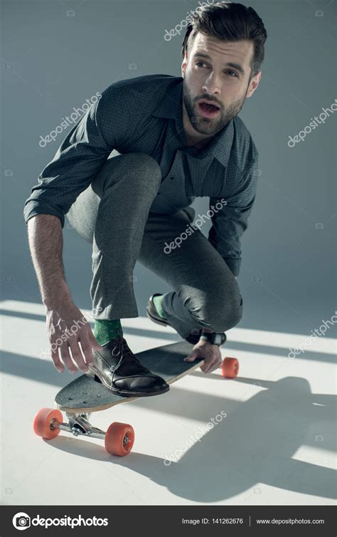 Stylish Man Riding Skateboard — Stock Photo © Arturverkhovetskiy 141262676