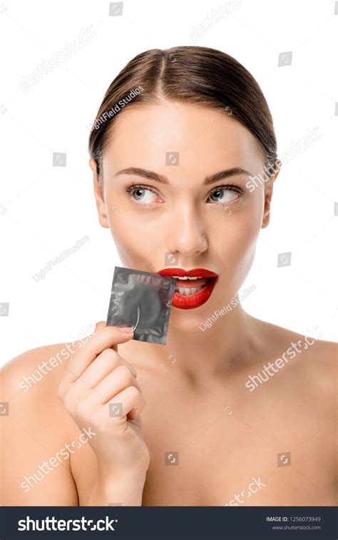 Attractive Naked Girl Holding Condom Looking Stok Fotoğrafı 1256073949