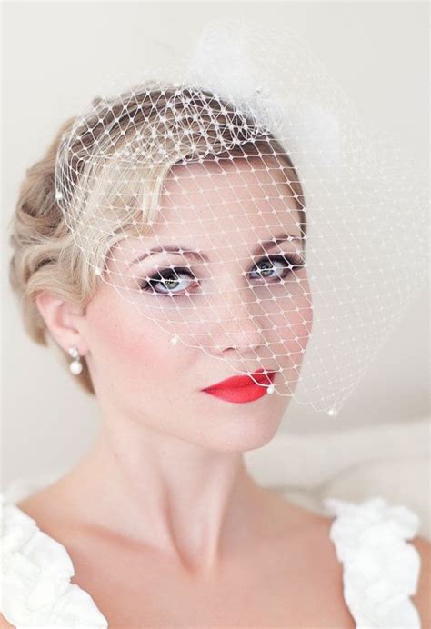 okay we love her birdcage veil we love her flawless makeup and we love her gorgeous hair so