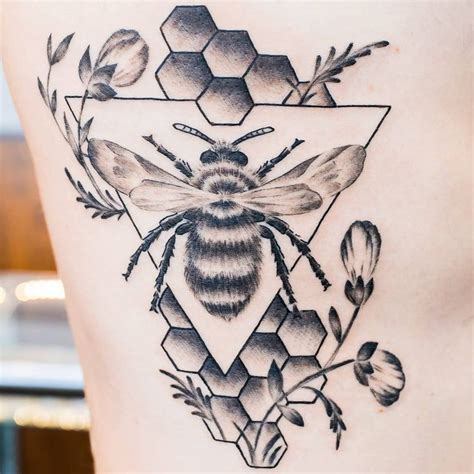 A Black And White Photo Of A Bee On The Back Of A Womans Thigh