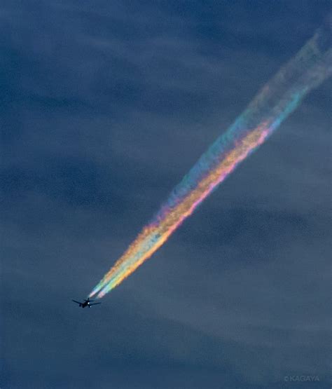 A Photographer Captures An Airplane With Rainbow Contrails Above Japan