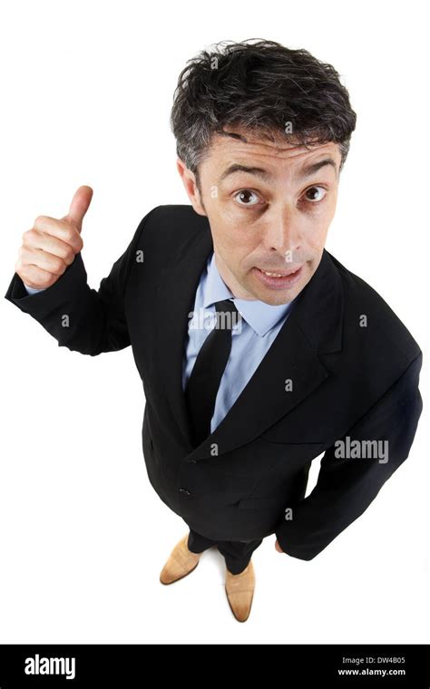 Businessman Giving A Thumbs Up Gesture While Giving The Camera A Smug