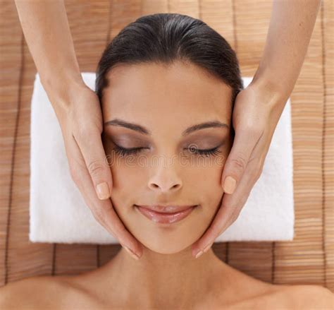 Whole Body Care A Young Woman Enjoying A Head And Face Massage At A Spa Stock Image Image Of