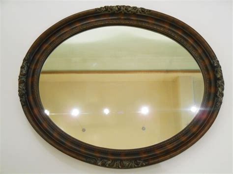 Oval Mirror Framed In Wood With Florettes