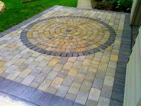 Do you have a small patio paver and need ideas? Square patio with a multi colored round paver in-lay ...
