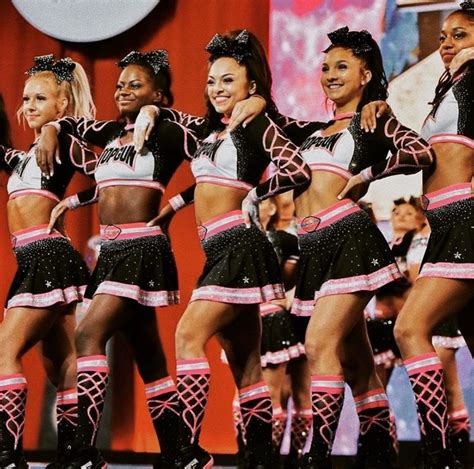 A Group Of Cheerleaders Standing On Top Of A Stage